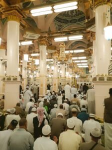 A crowd of worshipers praying inside the Prophet's Mosque, Saudi Arabia.
